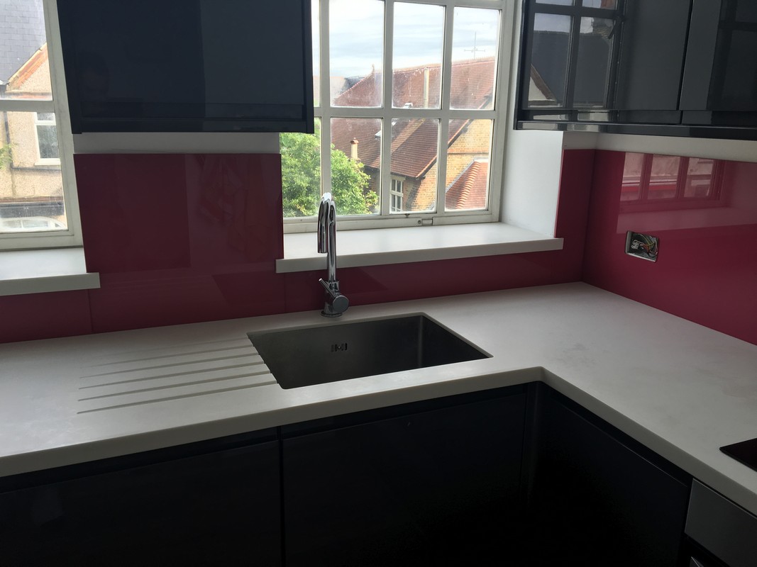 Deep plum coloured glass splashback in modern Morden kitchen