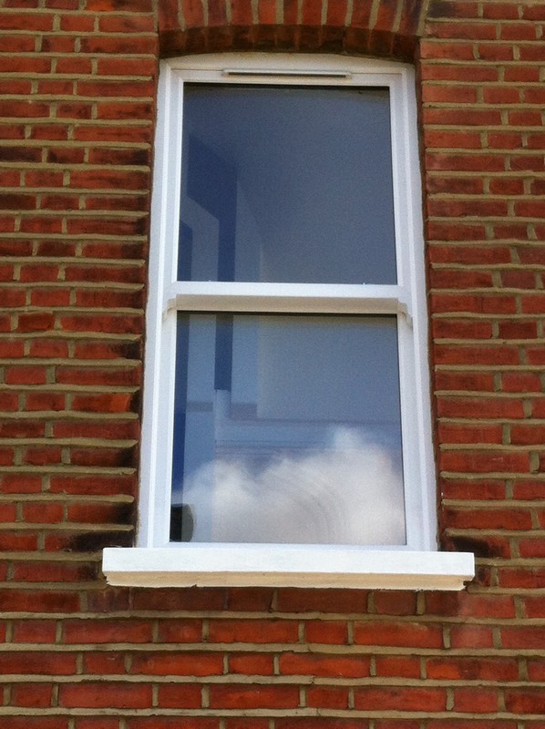 uPVC sash window on Victorian red brick house in Morden